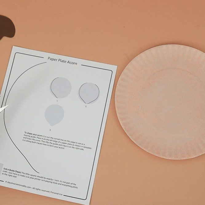trace acorn shape on paper plate