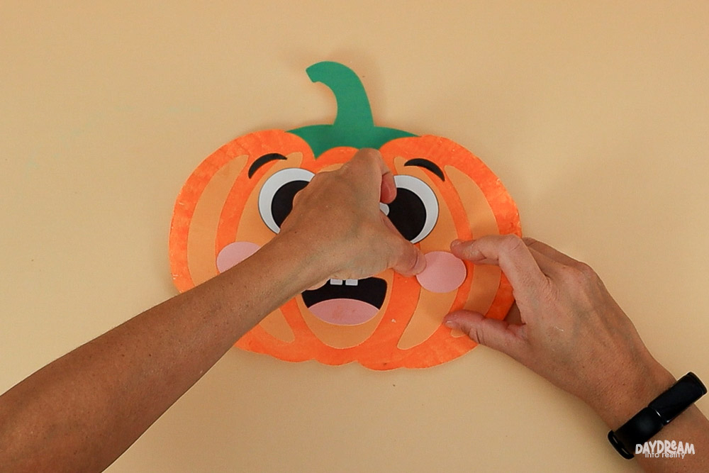 placing cheeks on pumpkin