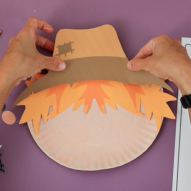 gluing hat to scarecrow