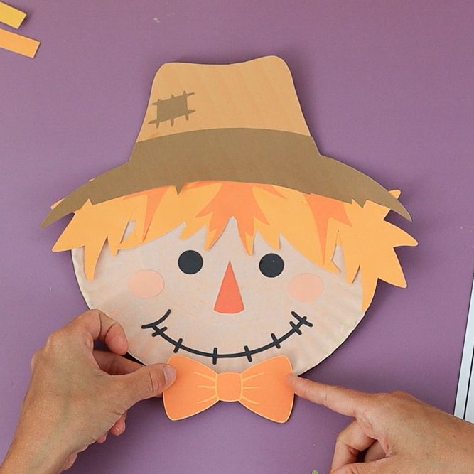 paper plate scarecrow with bow tie and jagged hair