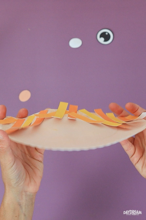 Straight straw hair for paper plate scarecrow craft, partially glued for a layered 3D effect