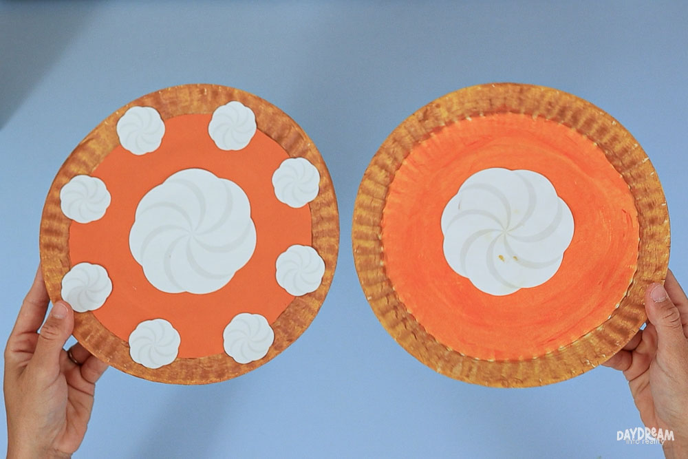 comparison of paper plate pumpkin pies one with glued filling, the other one with painted filling