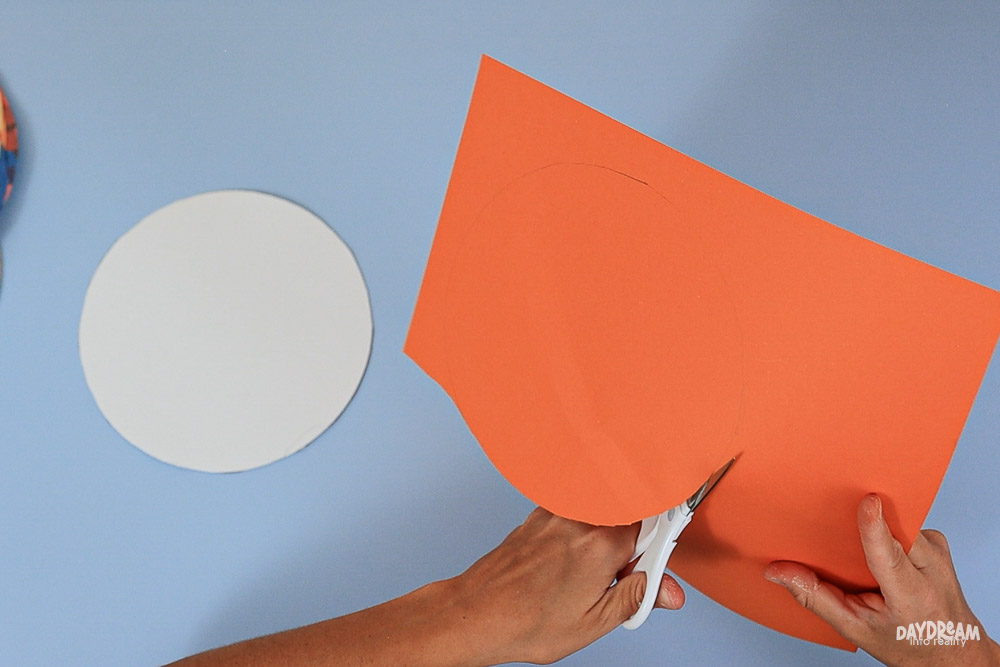 cutting out the orange pie filling circle