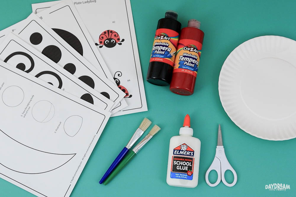 Materials for making a ladybug with paper plates.