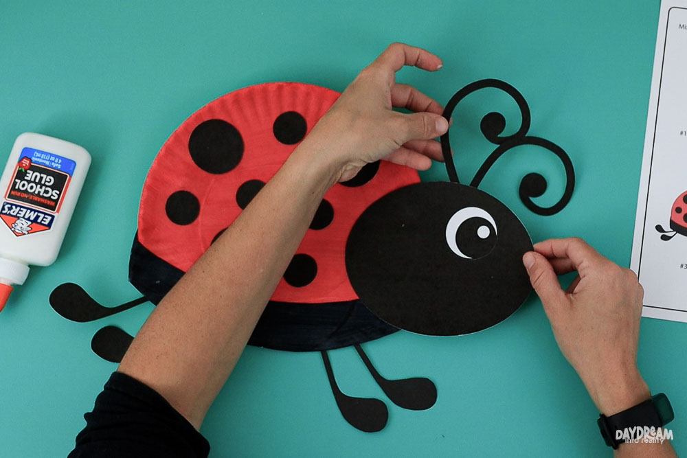 Glue antennae to ladybug.