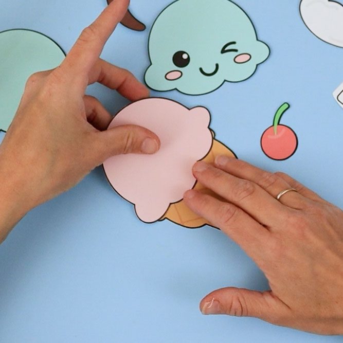 Attaching the pink ice cream scoop to the cone.