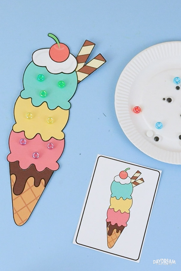 Easy ice cream craft for kids sprinkled with colorful beads featuring a printable triple scoop ice cream cone summer craft template.