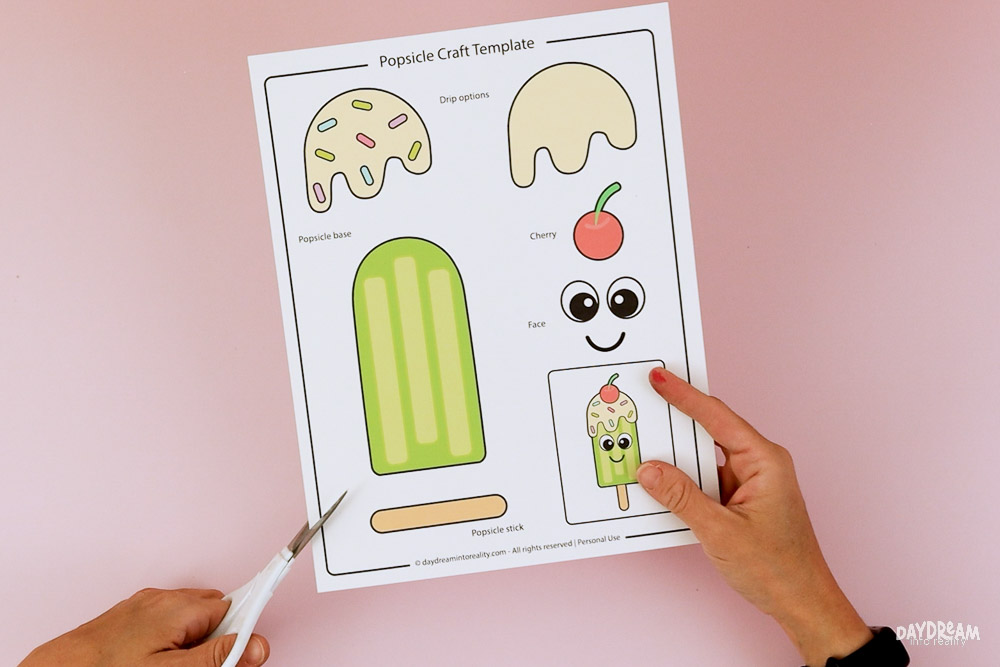 Cut out the printable popsicle craft template pieces with scissors.