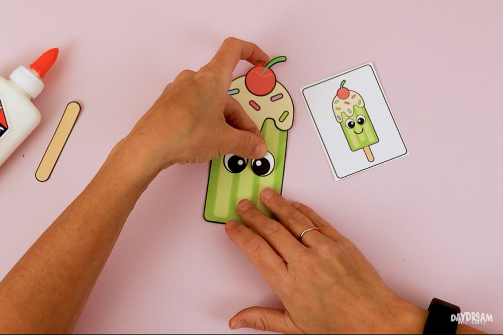 Glue the eyes, to the popsicle