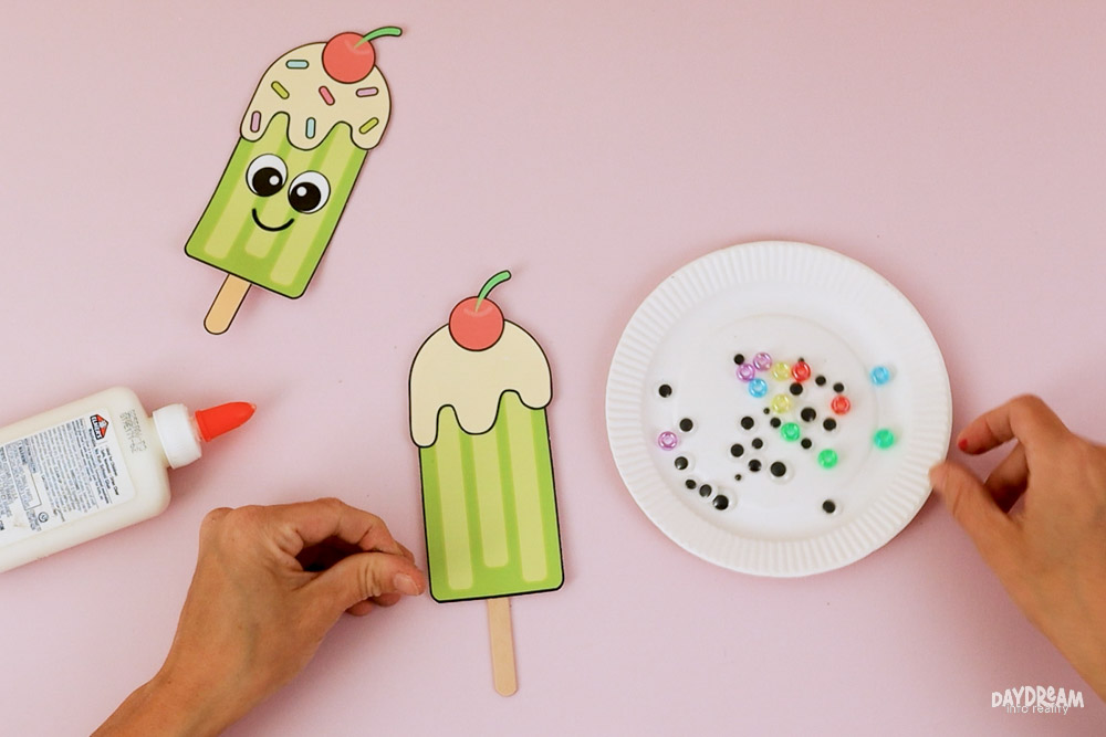 Use different craft supplies for your popsicle. Real popsicle sticks, googly eyes, and beads!
