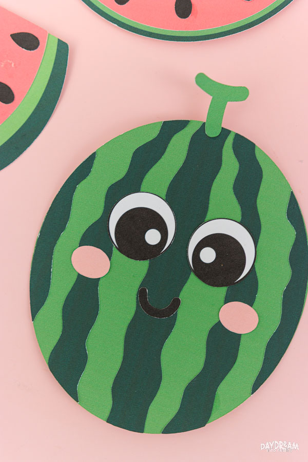Cute whole watermelon craft for kids with smiling kawaii face and striped watermelon design.