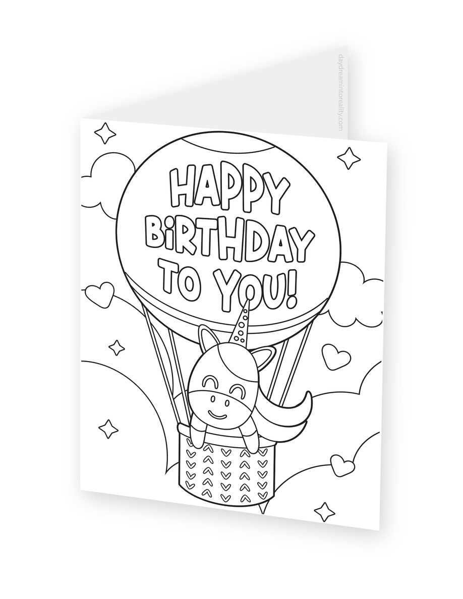Foldable coloring card featuring a unicorn riding in a hot air balloon.