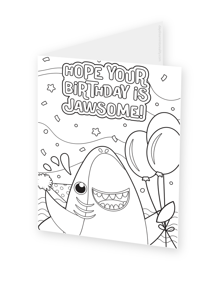 Foldable coloring card featuring a smiling shark wearing a party hat and holding balloons beneath a Jawsome Birthday message.